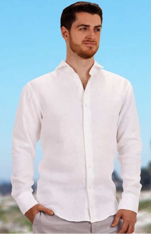Man wearing a white linen button-down shirt with a relaxed band collar, styled against a bright blue sky background