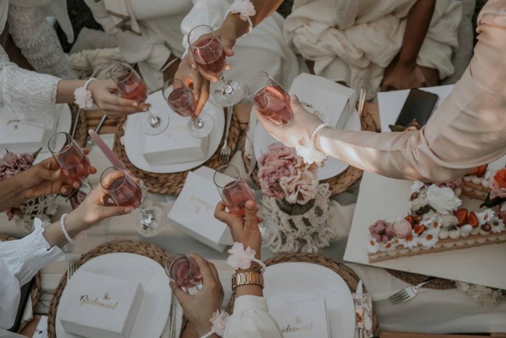 Bridal shower toast with pink drinks and floral decor, showcasing destination wedding inspiration by Breezy Brides.