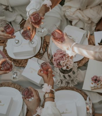 Bridal shower toast with pink drinks and floral decor, showcasing destination wedding inspiration by Breezy Brides.